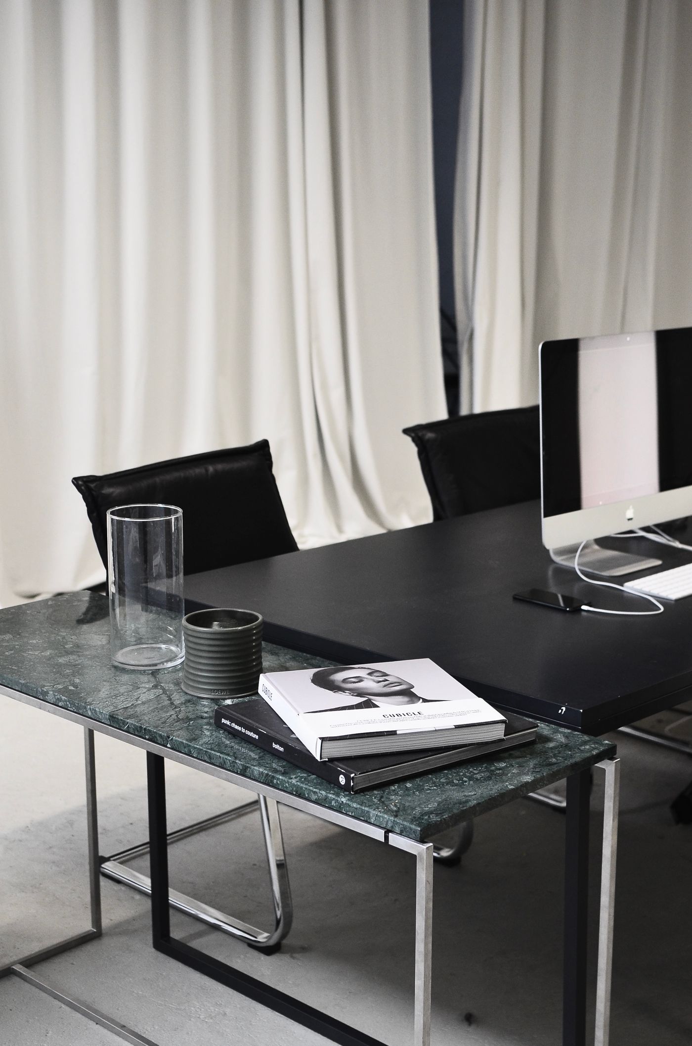 Quiet professional workspace with a meeting table and computer